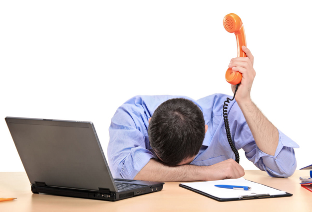 Exhausted businessman holding a telephone tube