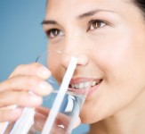 A young woman drinking a glass of water. Image shot 2006. Exact date unknown.