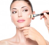 Makeup artist applying liquid tonal foundation  on the face